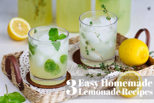 lemonade with ice in clear glass on top of clothes inside a tray