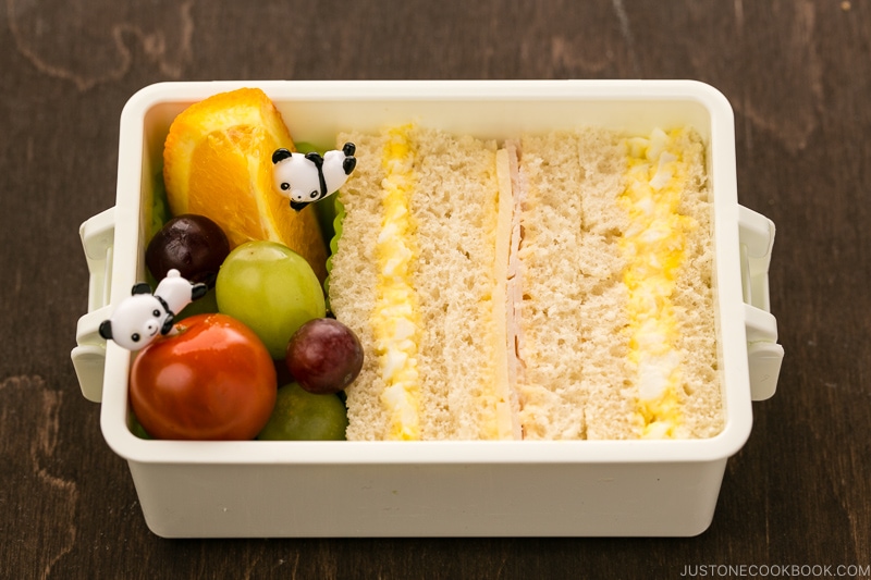 Egg salad sandwich and fruits in the bento box