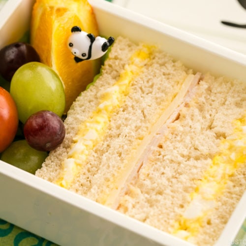 Egg salad sandwich and fruits in the bento box