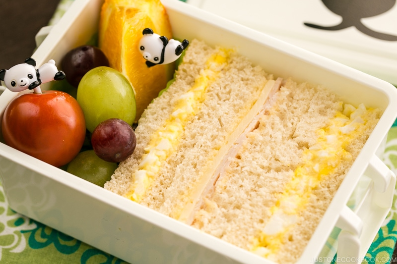 Egg salad sandwich and fruits in the bento box