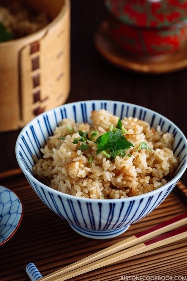 A blue and white Japanese rice bowl containing seasoned mixed rice with sweet onion.