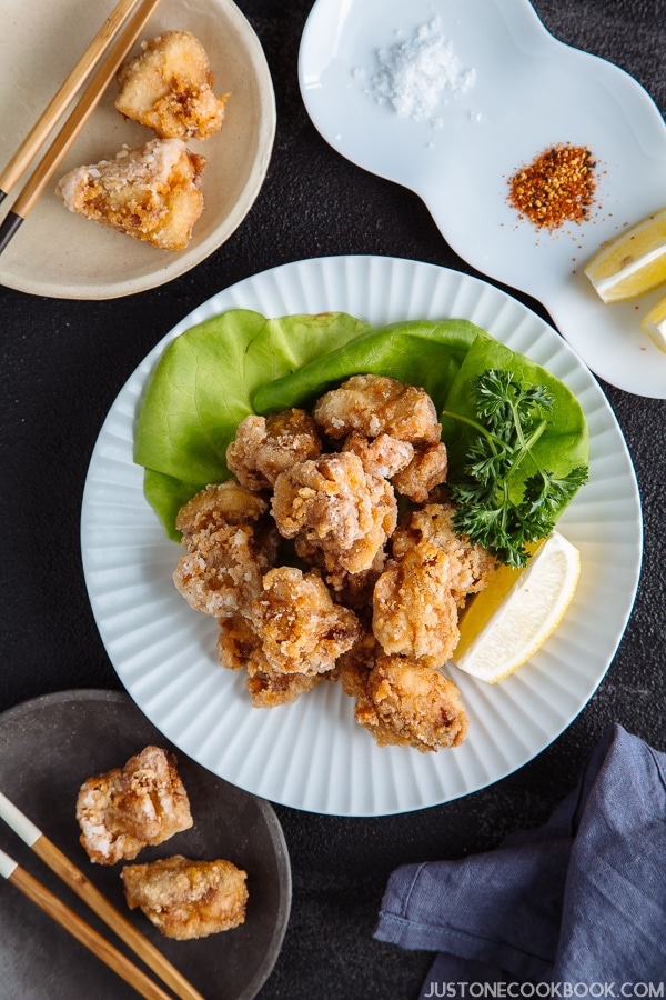 Gluten Free Karaage (Japanese Fried Chicken) on a white plate with sliced lemon.