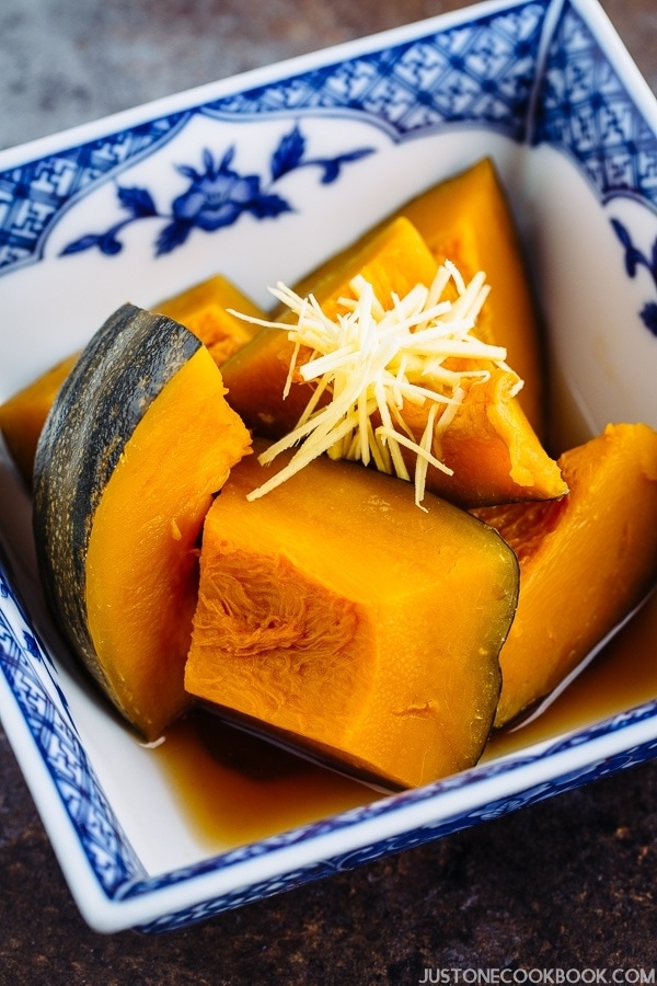 Close up shot of Simmered Kabocha Squash (Japanese Pumpkin) in a Japanese blue willow bowl.