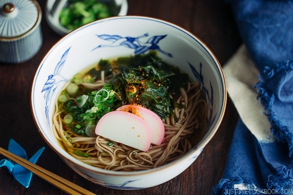 Toshikoshi Soba Noodle Soup with fish cake and wakame seaweed in a Japanese bowl.