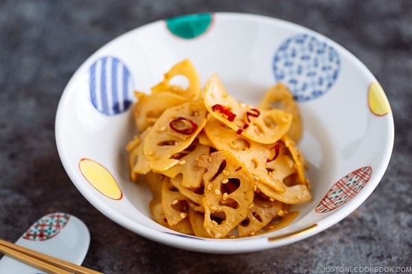 A round colorful Japanese bowl containing Kinpira Renkon (Japanese Lotus Root Stir Fry).