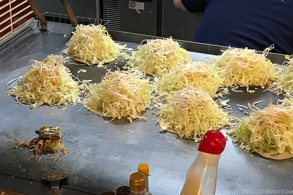Mitchan Okonomiyaki with cabbage and bean sprout being grilled | Hiroshima Japan Guide JustOneCookbook.com