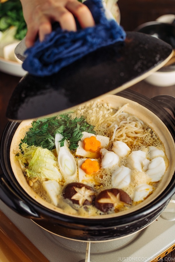 Monkfish hot pot in a black Japanese earthenware donabe.