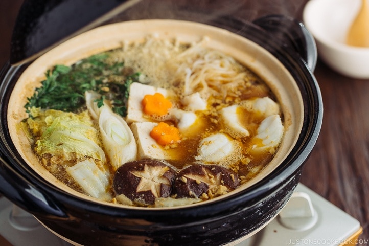 Monkfish hot pot in a black Japanese earthenware donabe.