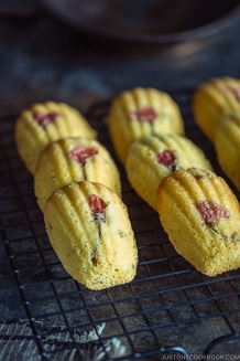 Cherry Blossom Madeleines laid staggered on a wire rack.
