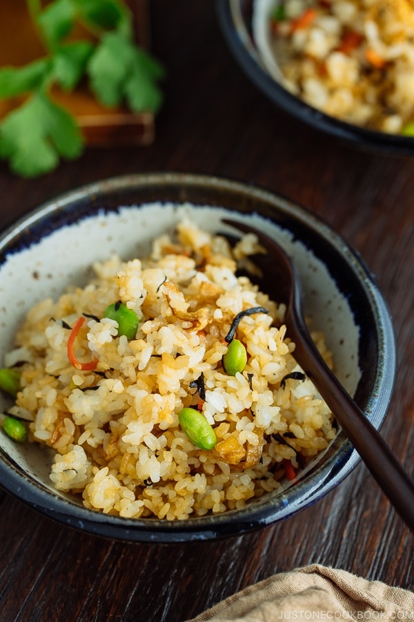 Japanese Fried Rice with Edamame, Tofu and Hijiki Seaweed in a rustic bowl served with wooden fork