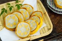 Karashi Renkon - deep fried lotus root stuffed with Japanese hot mustard miso on a bamboo basket.