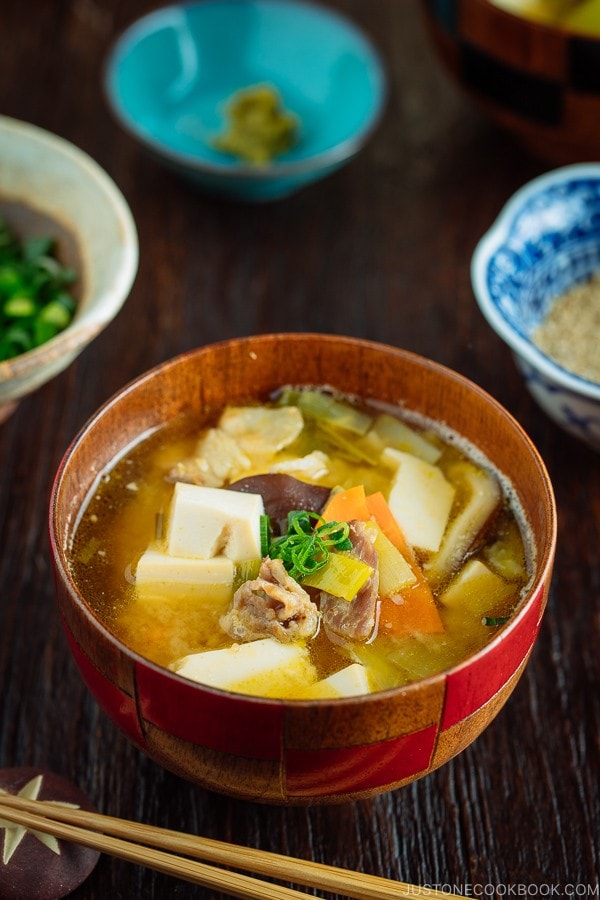 Pork belly and vegetable miso soup in a wooden bowl.