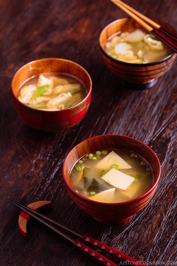 Three kinds of vegetable miso soups, each served in a wooden bowl.