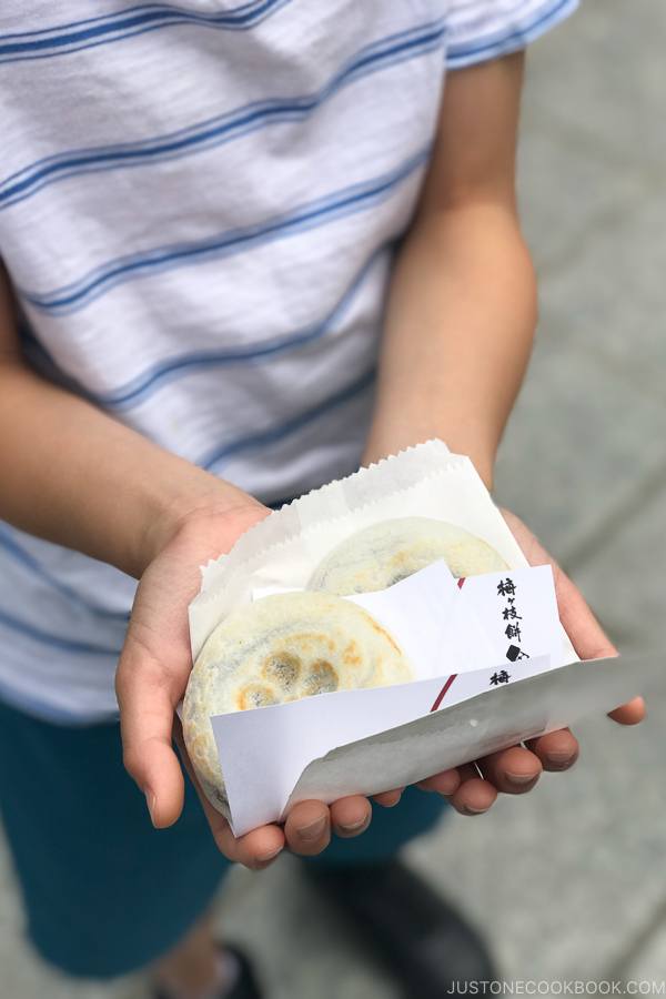 umegaemochi in children's hands - Dazaifu speciality sweet - Fukuoka Travel Guide | justonecookbook.com