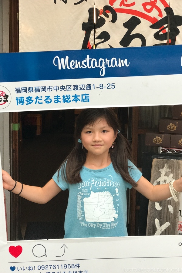 child with Instagram sign in front of Hakata Daruma - Fukuoka Travel Guide | justonecookbook.com