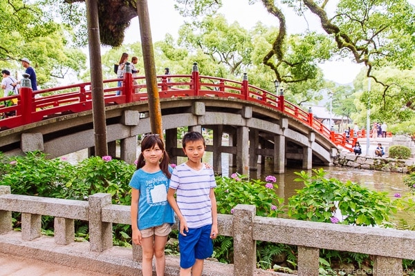 children standing in front of Taiko Bridge at Dazaifutenmangu - Fukuoka Travel Guide | justonecookbook.com