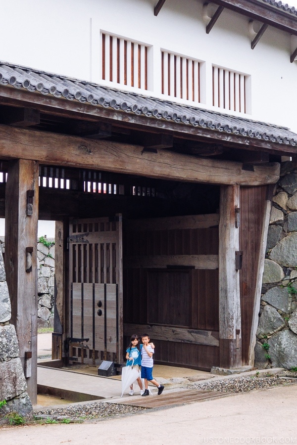 children standing inside Fukuoka Castle Gate - Fukuoka Travel Guide | justonecookbook.com