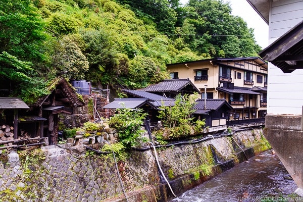 view of river and Shinmei-kan 山の宿 新明館 - Kurokawa Onsen Travel Guide | justonecookbook.com
