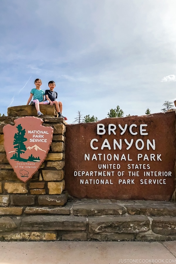 children on top of Bryce Canyon National Park sign - Bryce Canyon National Park Travel Guide | justonecookbook.com