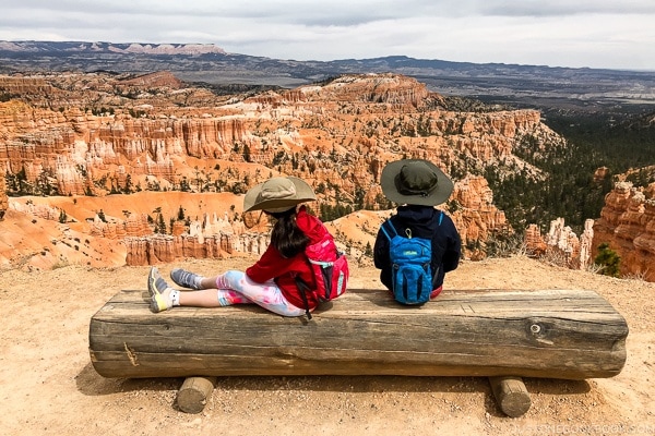 children on a bench on the rim trail near Sunset Point - Bryce Canyon National Park Travel Guide | justonecookbook.com