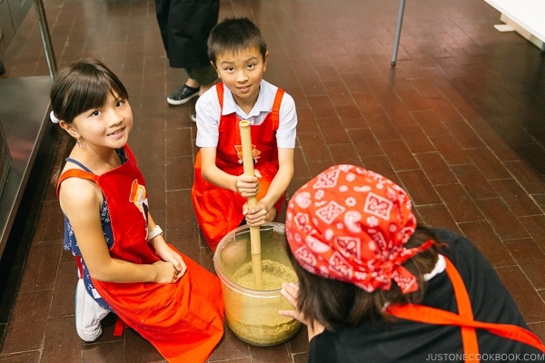 children mixing soy sauce mixture at at Kikkoman Factory in Noda Japan | justonecookbook.com