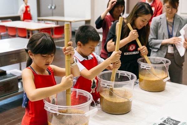 Nami and children mixing soy sauce mixture at Kikkoman Factory in Noda Japan | justonecookbook.com