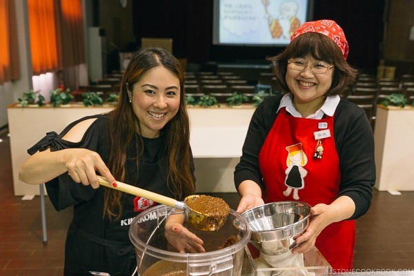 Nami pouring soy sauce mixture into fabric bag at Kikkoman Factory in Noda | justonecookbook.com