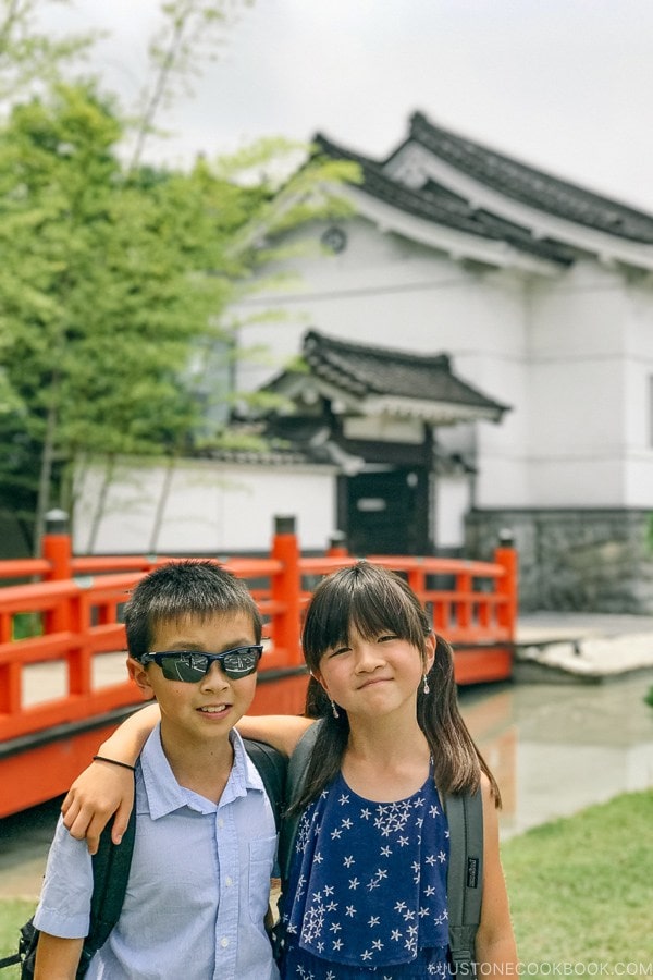 children in front of Imperial soy sauce brewery at Kikkoman Factory in Noda Japan | Kikkoman Factory Tour - justonecookbook.com