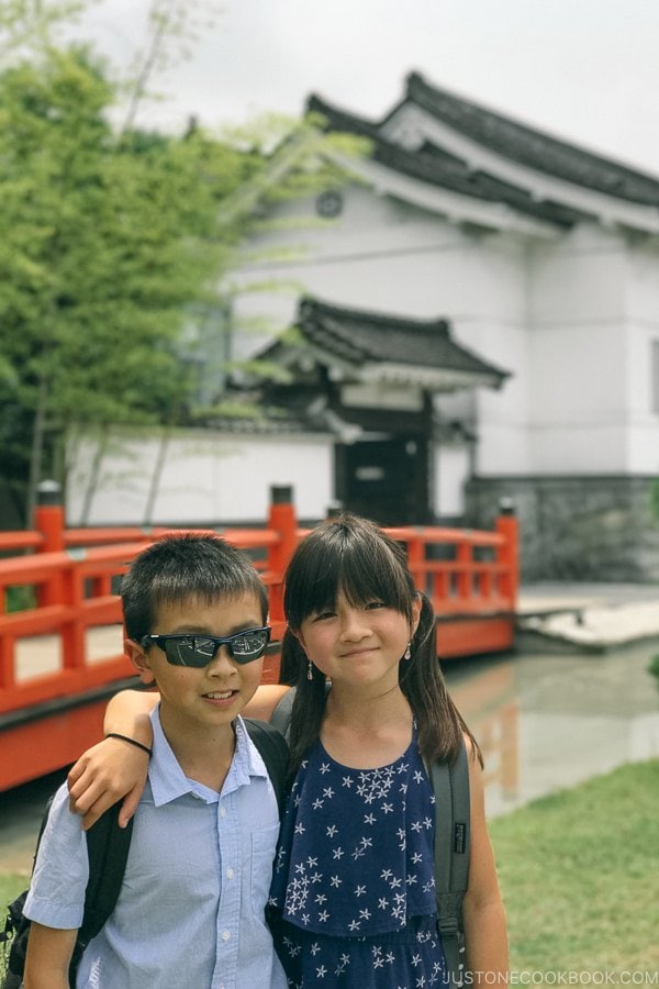 children in front of Imperial soy sauce brewery at Kikkoman Factory in Noda Japan | Kikkoman Factory Tour - justonecookbook.com