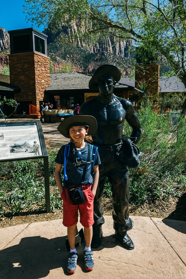 child in front of statue near Zion visitor center - Zion National Park Travel Guide | justonecookbook.com