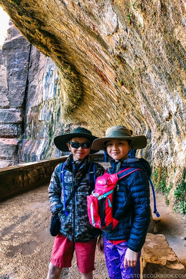 children standing inside Weeping Rock Trail - Zion National Park Travel Guide | justonecookbook.com