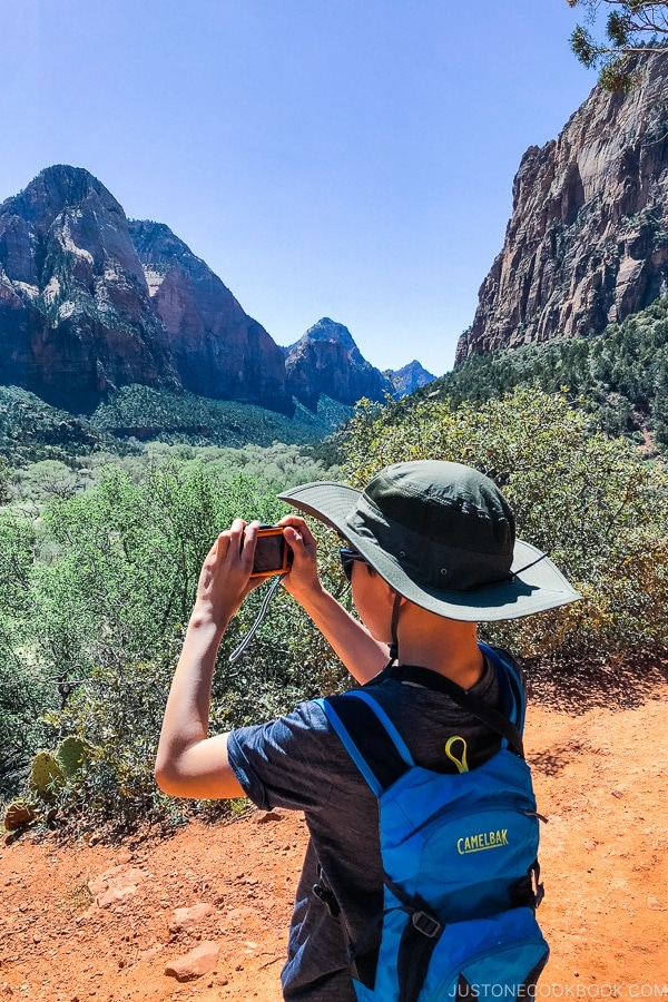 child taking photo on Kayenta Trail - Zion National Park Travel Guide | justonecookbook.com