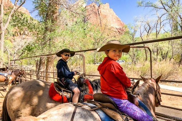 children on horses inside corral at Zion - - Zion National Park Travel Guide | justonecookbook.com