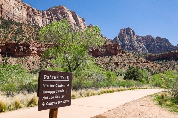 sign on the Pa'rus Trail pointing visitor center and canyon junction - Zion National Park Travel Guide | justonecookbook.com