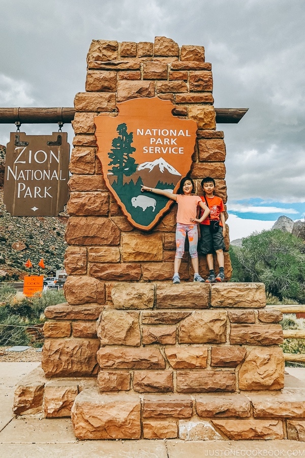 children standing on the Zion National Park sign - Zion National Park Travel Guide | justonecookbook.com
