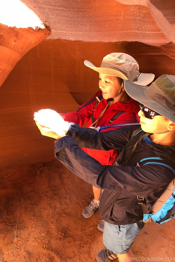 children with a beam of light shining at their hands - Lower Antelope Canyon Photo Tour | justonecookbook.com