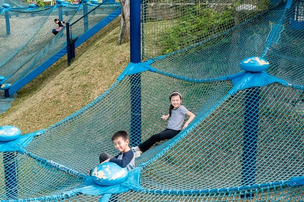 children playing at outdoor playground in front of Churaumi aquarium at Ocean Expo Park Okinawa | justonecookbook.com