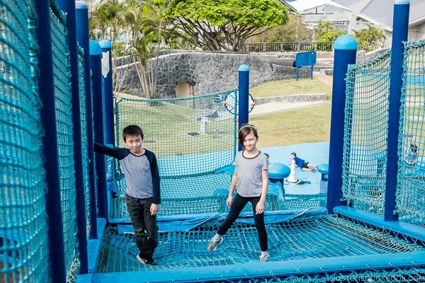 children playing at outdoor playground in front of Churaumi aquarium at Ocean Expo Park Okinawa | justonecookbook.com