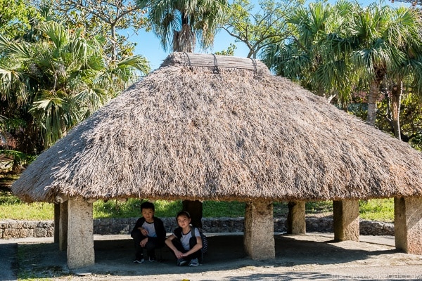 children under traditional Ryukyu grass hut at Ocean Expo Park Okinawa | justonecookbook.com