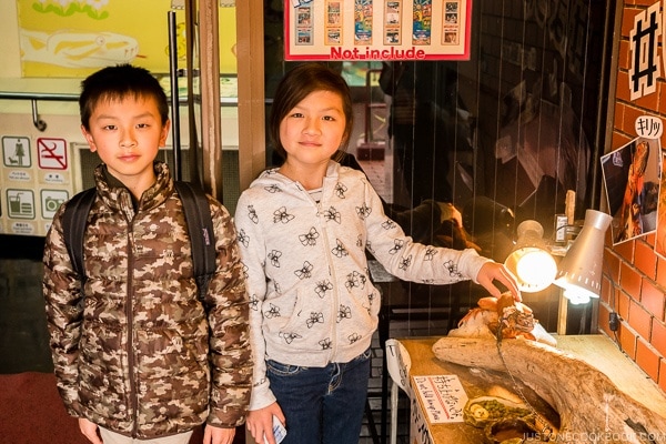 children standing next to lizard on display at Habu Park - Okinawa World | justonecookbook.com