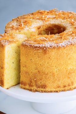 Orange Chiffon Cake on top of the cake stand. Chiffon cake has a hint of cardamom and powder sugar dusted on top.
