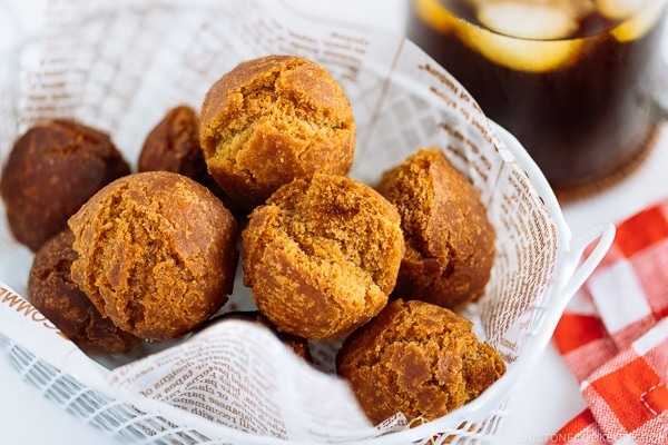 Sata Andagi (Okinawan Doughnuts) in a white basket.