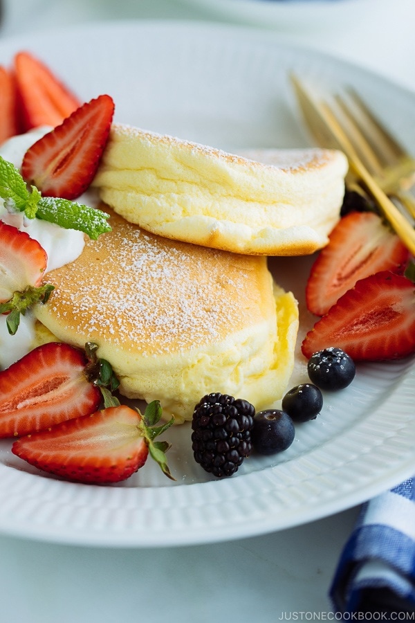 Japanese Souffle Pancakes with berries and fresh whipped cream.