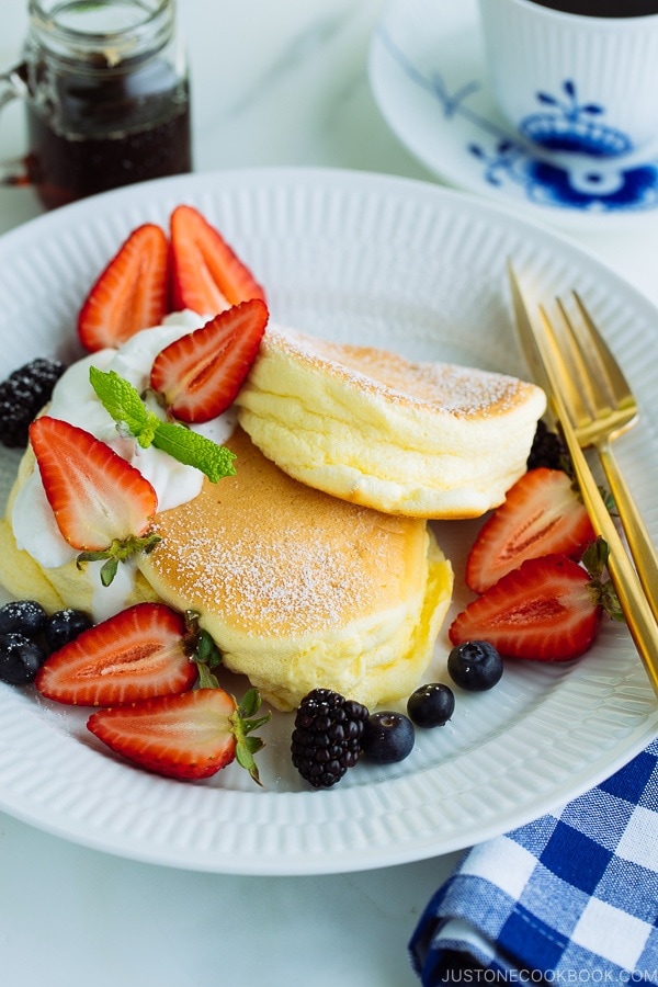 Japanese Souffle Pancakes with berries and fresh whipped cream.