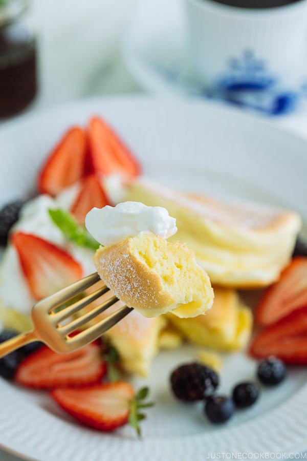 Japanese Souffle Pancakes with berries and fresh whipped cream.