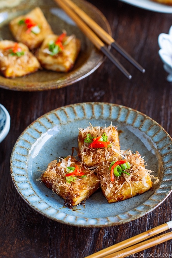 Three pieces of Teriyaki Tofu are placed on a Japanese blue plate | Easy. Japanese Recipes at JustOneCookbook.com