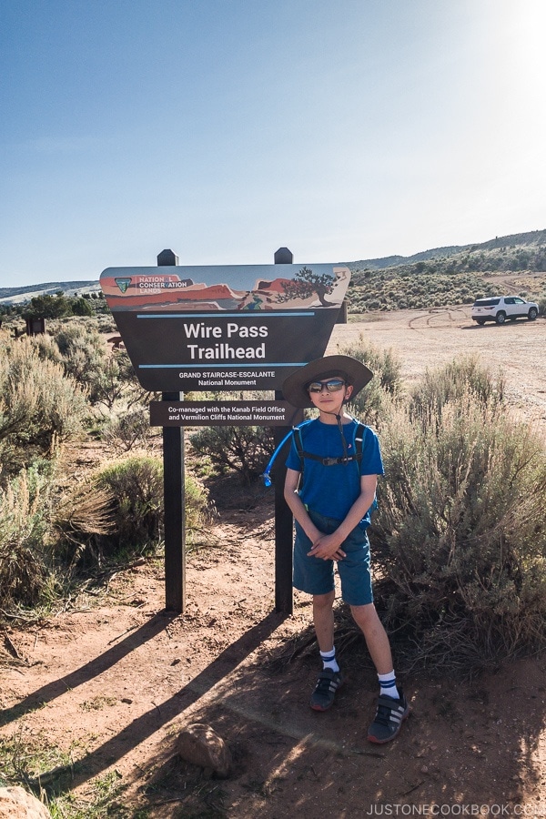 child standing in front of Wire Pass Trailhead Sign | justonecookbook.com