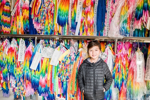 child in front of folded cranes at Himeyuri Peace Museum - Okinawa Travel Guide | justonecookbook.com