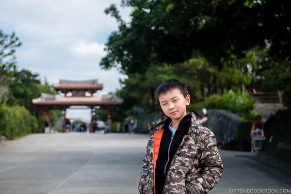 child at Shuri Castle with Shureimon Gate in the background - Okinawa Travel Guide | justonecookbook.com