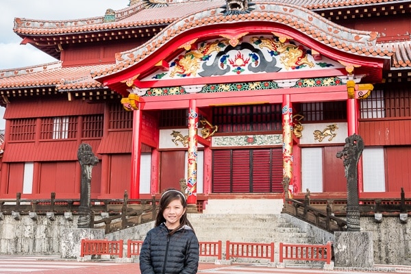 child in front of restored Shuri Castle Seiden - Okinawa Travel Guide | justonecookbook.com